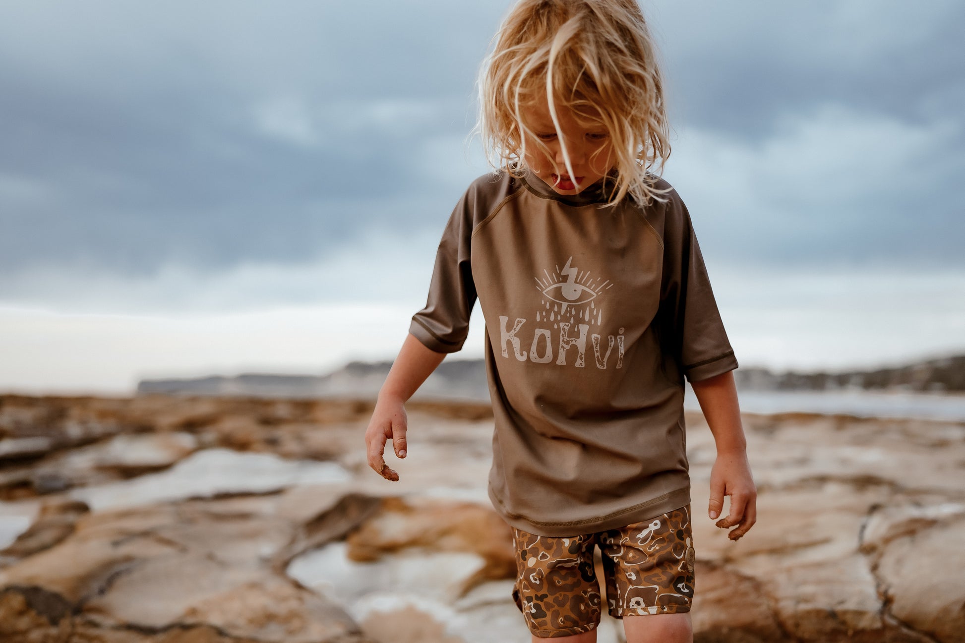 Kohv wearing the reversible rash shirt designed by Australian Children's surf clothing brand, Kohvi Kids.