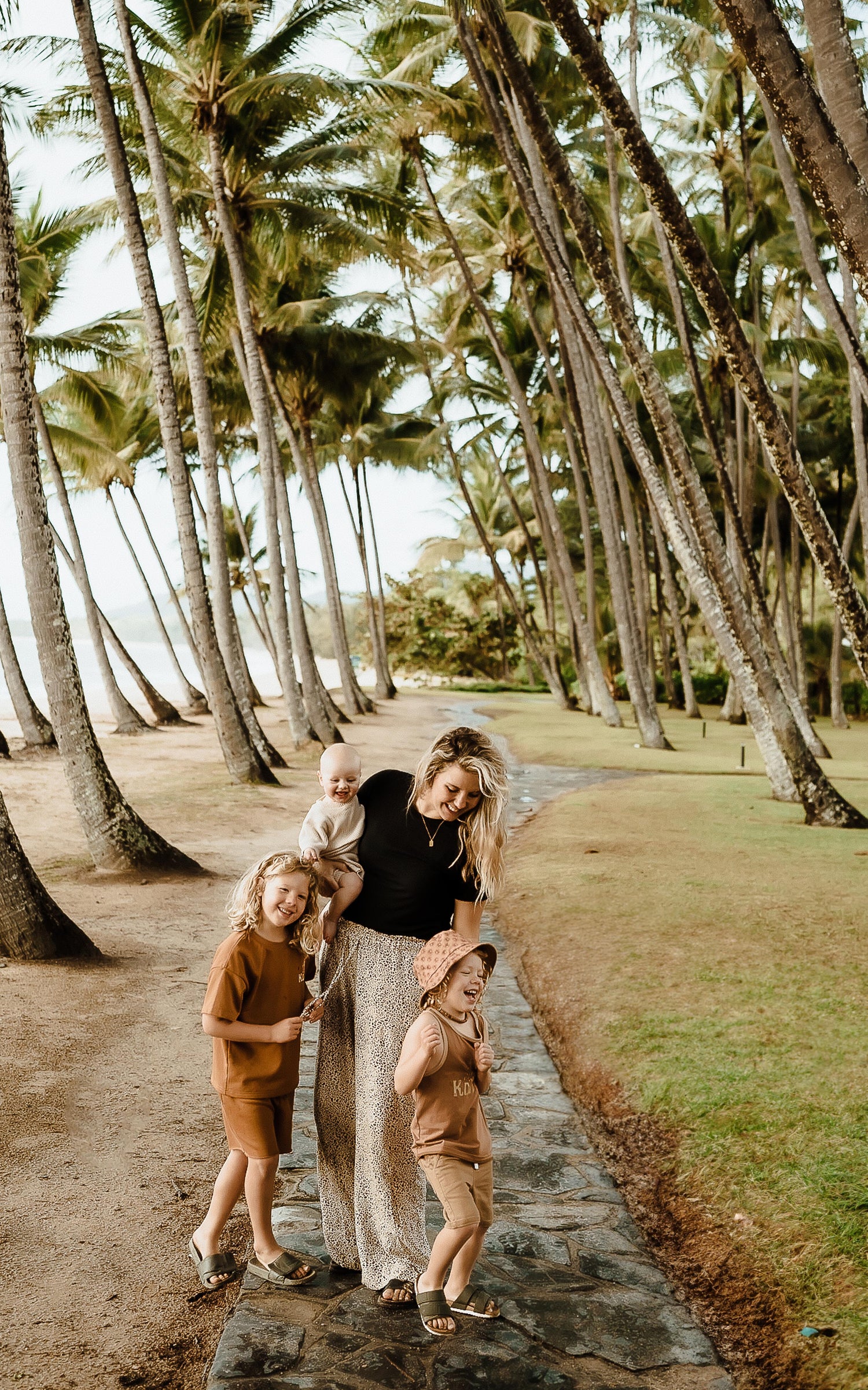 Photo of Kendell Tyne, founder and designer of boy's clothing brand, Kohvi. Photgraphed with her 3 sons, wo are her inspiration behind her clothing designs.