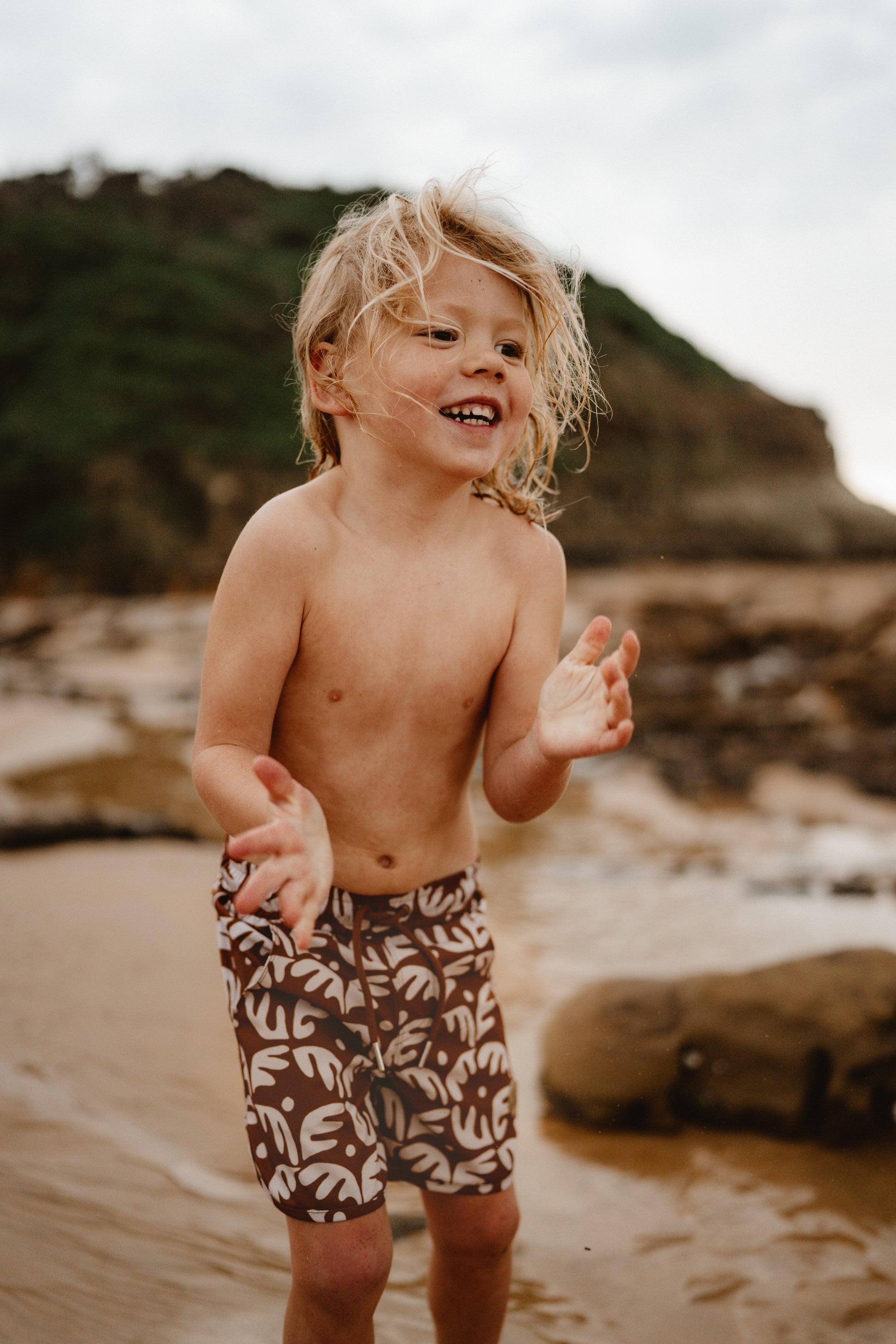 Kohv wearing the Kohvi Brown Coral board shorts at Avoca rockpools and beach